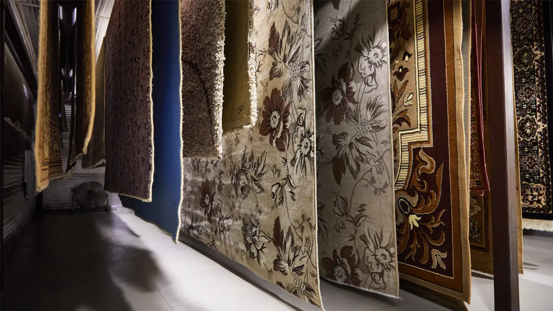 Hanging rugs in a display area